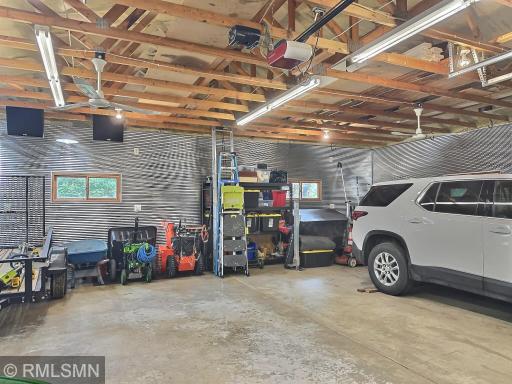 The detached garage offers ample space for additional vehicles, boats, and more. Itâs finished with corrugated tin, a concrete floor, ceiling fans, and plenty of fluorescent lighting.