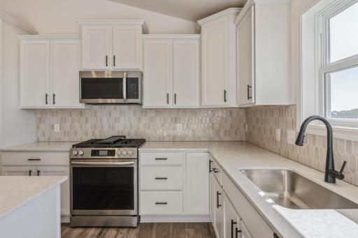 (Photo of similar home features will vary) The kitchen extends into the dining room for effortless transitions between cooking and eating