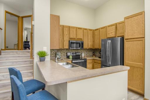 Kitchen offers updated stainless steel appliances and designer backsplash.
