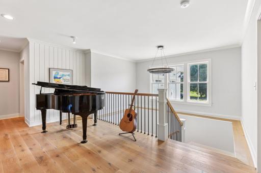 Inviting open foyer featuring wide plank white oak floors which is found on both levels of the home