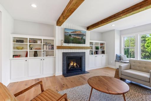 Fireplace and custom built-ins center the living room