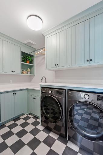 Main level laundry with an abundance of storaghe