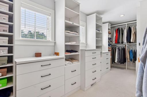 Primary Bedroom closet with custom built in closet syetem