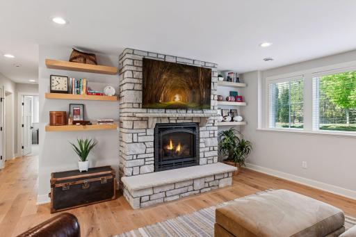 White oak shelStone fireplace warms the lower level family room