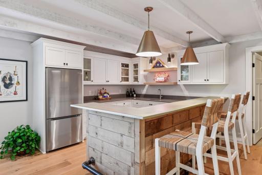 Full bar with barn wood ceiling, zinc top and an abundance of cabinet & countertop space