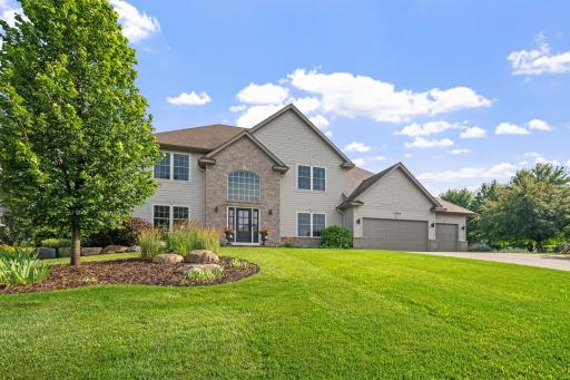 Front facade boasts Hardie shake and lap siding with brick accents and perimeter wrapped in vinyl