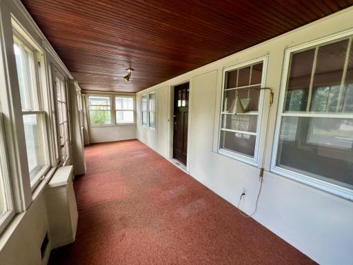 Large front porch with wooden slat ceiling
