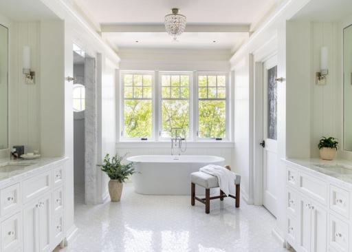 Bright, airy, and beautifully appointed—this primary bath features a deep soaking tub designed for quiet escapes. Photo of a primary ensuite bathroom designed and built by BCD Homes