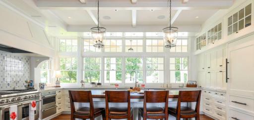 Thoughtfully crafted with refined finishes and timeless design, this kitchen is the centerpiece of an exceptional home. Photo of a kitchen designed and built by BCD Homes.