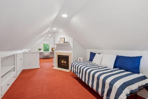 Light & bright upper level Den (or bedroom suite!) with a gas fireplace.