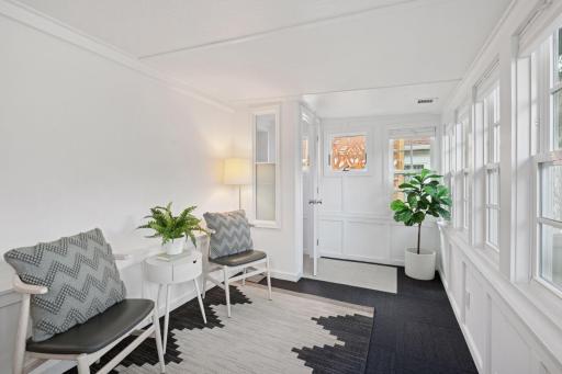 The sunroom just beyond the kitchen is a great family room, office space or playroom. Newer windows too!