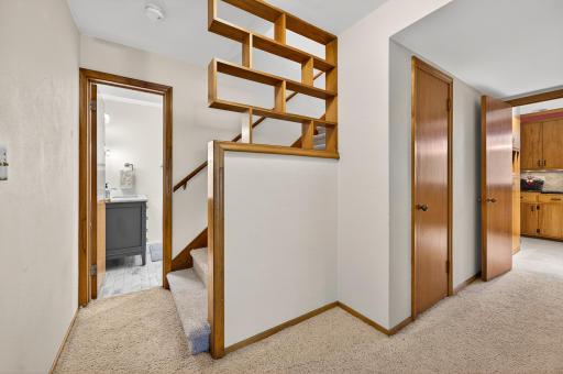 As you descend to the lower level, the door shown opens to the second bathroom.