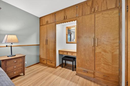 A wall of built-in, armoire style clothes closets, cabinets and drawers complete the Primary bedroom.
