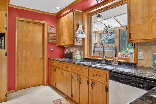 The window above the kitchen sink looks out to this darling greenhouse.