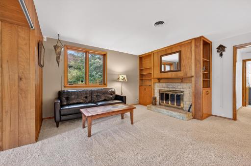 When the weather gets cold, add some additional warmth to the family room by firing up this woodburning fireplace.