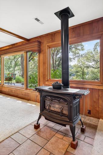 Enjoy the additional source of supplemental heat provided by this charming cast iron stove fueled by natural gas. The entire wall of west-facing Marvin windows provides gorgeous views of Lily Lake.