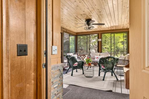 The door in the informal dining room opens to the natural light-filled screen porch.
