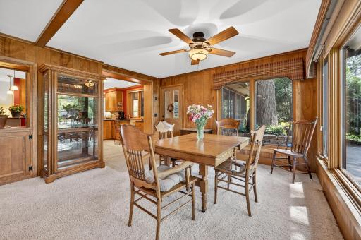 Informal dining area has a lovely five-blade ceiling fan and light set overhead. The window looks out to the backyard patio.