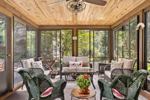 The ceiling of the screen porch is expertly crafted using tongue and groove knotty pine.
