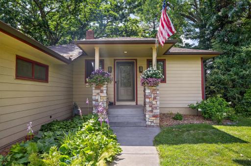 The stacked limestone-wrapped support columns add a classy, architectural detail to the inviting front entrance.