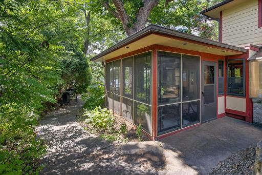 The screen porch measures 12 by 19 feet and provides outdoor access through two aluminum storm doors.