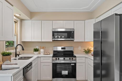 Brand new kitchen, including cabinets with soft close doors and drawers, quartz counters, stainless appliances, sink, and faucet, flooring, and fixtures!