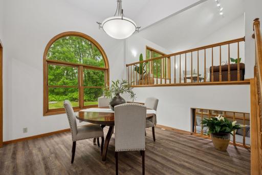Oversized windows frame picturesque views of the backyard sanctuary.