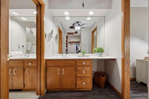 Primary ensuite has amble cabinetry and beaming light.