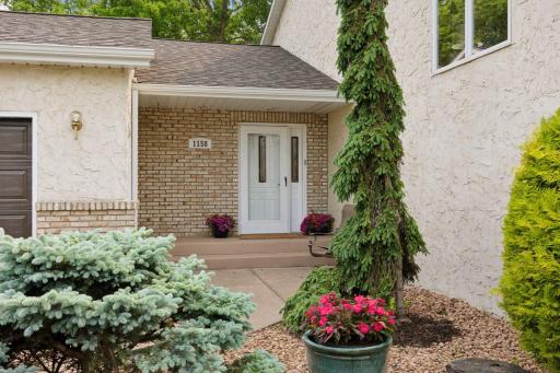 Exceptional curb appeal with manicured landscaping and timeless design.