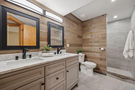 Sleek fixtures and warm finishes create a spa-like feel.