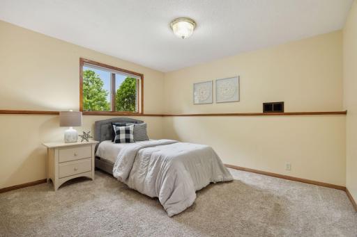 Lower level guest bedroom is large with views of the backyard.