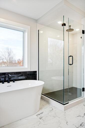 Spa-inspired bathroom featuring a walk-in shower and freestanding soaking tub