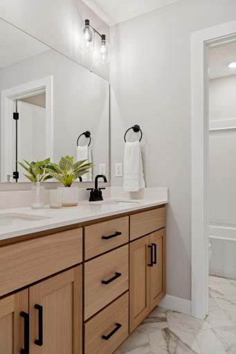 Full bathroom upstairs with dual sinks and private lavatory & shower