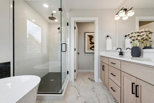 Spa-inspired bathroom featuring a walk-in shower and ample storage