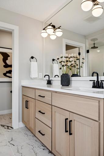 Beautiful primary bath with dual sinks and modern finishes