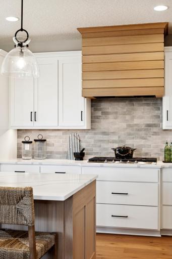 Custom cabinetry and designer inspired wood hood surround