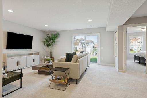 Walk out patio doors creating easy access to the backyard from lower level family room