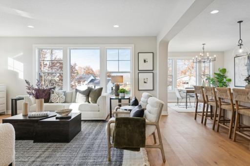 Open-concept living room with large windows and comfortable layout