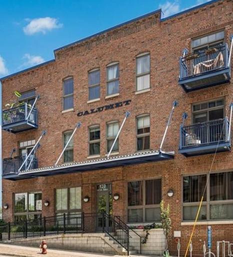 Historic Calumet Lofts building with rich architectural details including gorgeous exposed brick, heavy timber framing, and contemporary industrial touches.