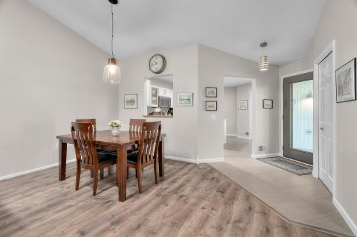 Dining room opens to the living room. The home is filled with multiple solar tube lights for loads of natural light.