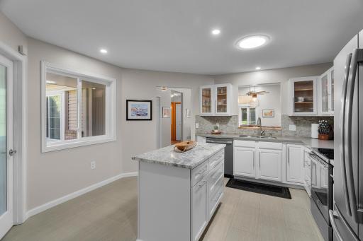 New center island with granite top and soft close doors. Notice the large window to enjoy wetland views while you cook and dine.