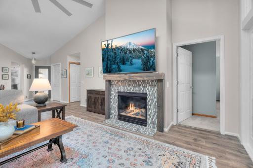 Stunning eye catching fireplace with tile detail and barnwood accents/mantle.