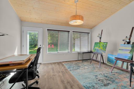 This sunfilled room is special with the wood ceiling and walks out to the patio.