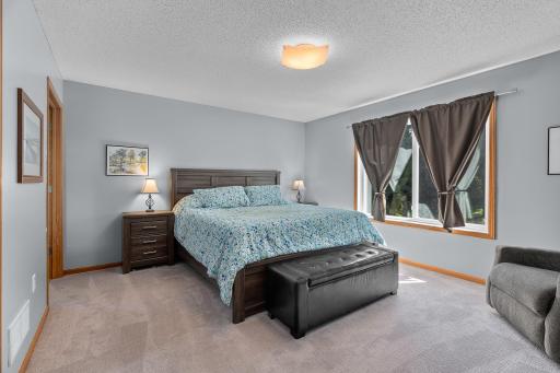 Enjoy a large primary suite overlooking the private backyard with nature views.