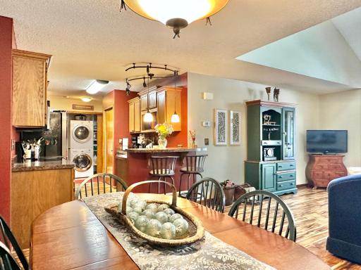 With a turn to the left is a look at the kitchen and laundry in the back ground.