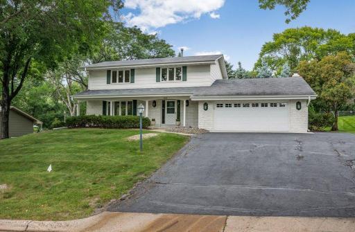 Welcome to 6809 Paiute Dr. Classic Colonial on a quiet street in a prime location with covered front porch..
