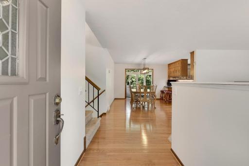 The home's entry foyer is large, bright and features oak hardwood flooring.