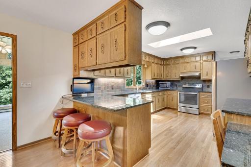 The kitchen is large at 16' x 11' in size and has direct access to the home's garage, laundry room and a 1/2 bathroom (access is to the right of the range and is not shown in photo).