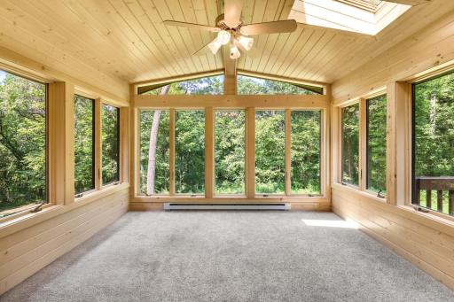 The home's fabulous sunroom is wrapped in Andersen windows that afford nature's views that are second to none!