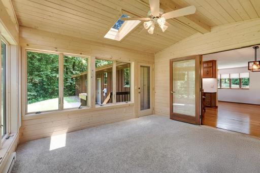 The sunroom is 13' x 13' in size and features natural solid wood paneling throughout complimenting the property's natural wildlife surroundings. The sunroom also provides backyard and deck access from the main floor.